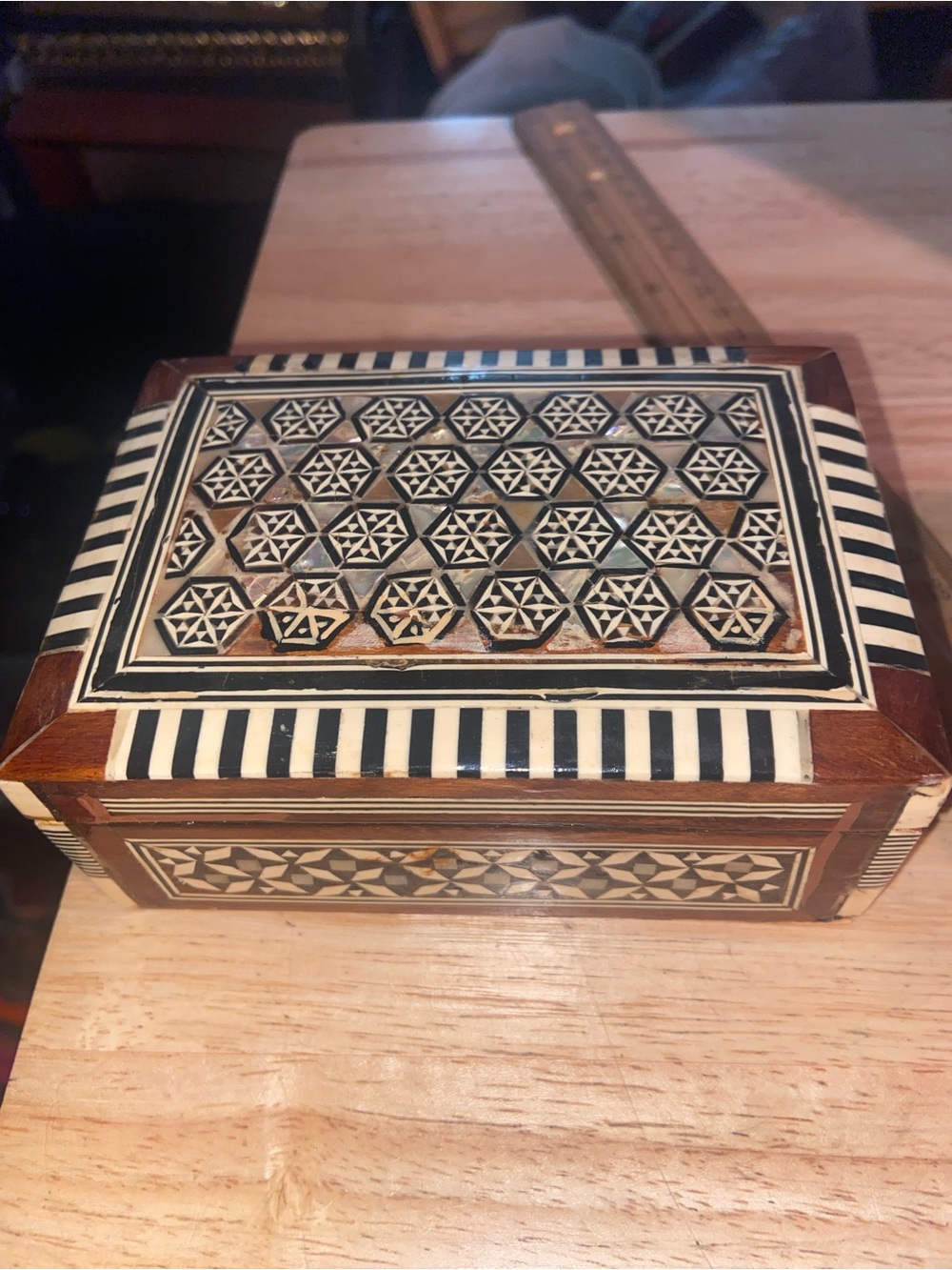 vintage wooden trinket or jewelry box featuring geometric mosaic inlay